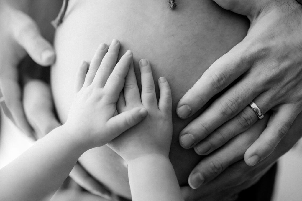 Maternity photography family session pregnant woman  with child and man in studio in Tampa Bay, Florida Nadine B Photography
