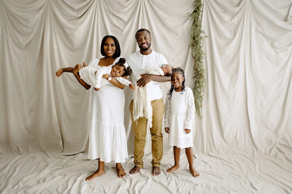 Newborn photography lifestyle session woman with man and children in studio in Tampa Bay, Florida Nadine B Photography