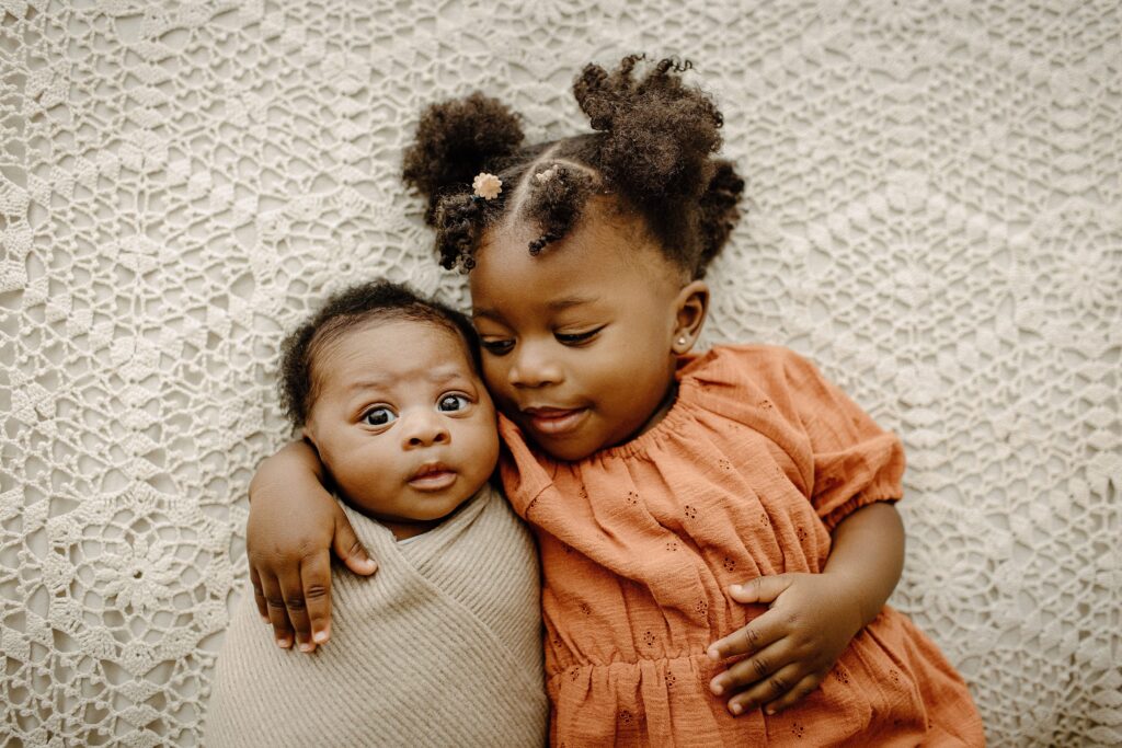 Newborn photography newborn session sibling with baby on bed in studio in Tampa Bay, Florida Nadine B Photography 