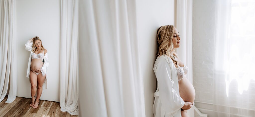 Pregnant woman in lace lingerie posing barefoot in white curtain backdrop for minimalist maternity boudoir shoot in Tampa studio