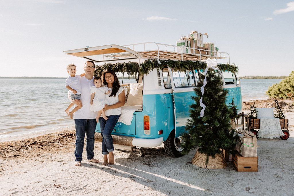 Christmas mini session setup with a decorated turquoise vintage blue bus on St. Pete Beach, Florida.