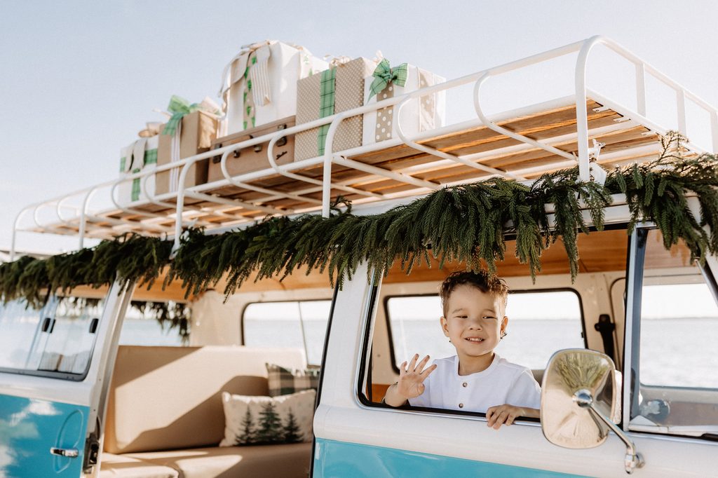 Christmas mini session setup with a decorated turquoise vintage blue bus on St. Pete Beach, Florida.