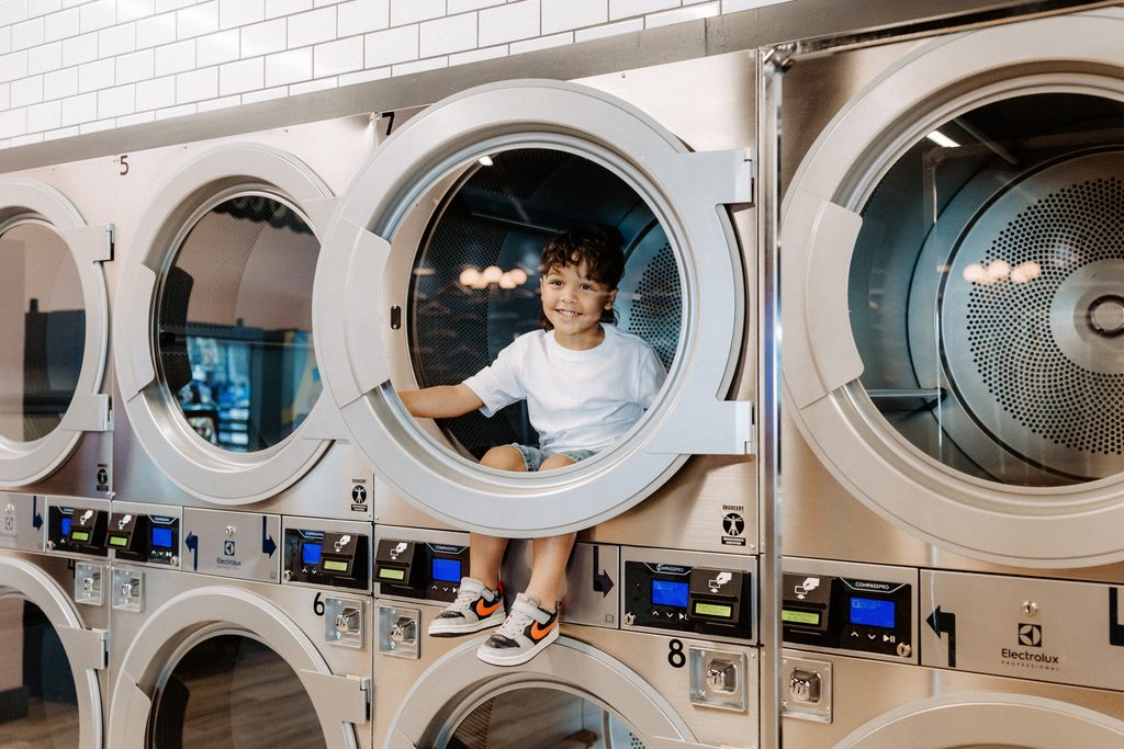 Lifestyle branding photography featuring family moments at Dirty Britches Laundromat in Spring Hill, Florida