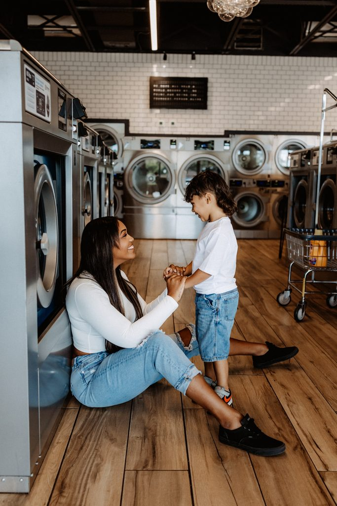 Lifestyle branding photography featuring family moments at Dirty Britches Laundromat in Spring Hill, Florida