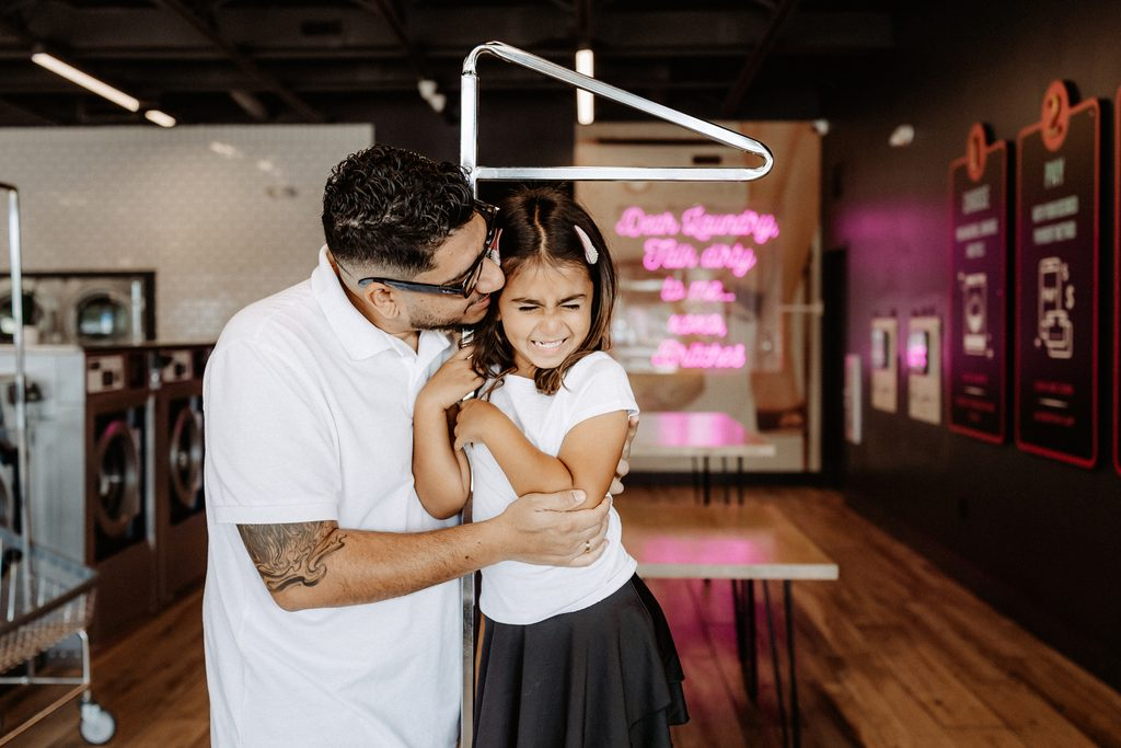 Lifestyle branding photography featuring family moments at Dirty Britches Laundromat in Spring Hill, Florida