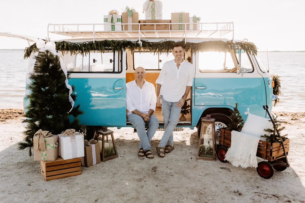 Christmas mini session setup with a decorated turquoise vintage blue bus on St. Pete Beach, Florida.