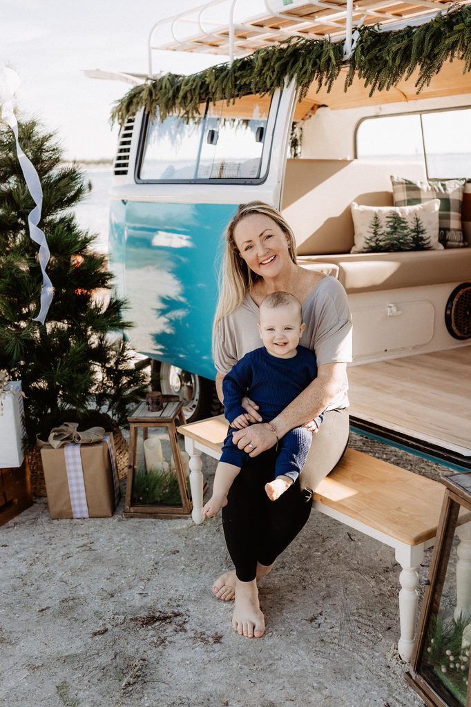 Christmas mini session setup with a decorated turquoise vintage blue bus on St. Pete Beach, Florida.