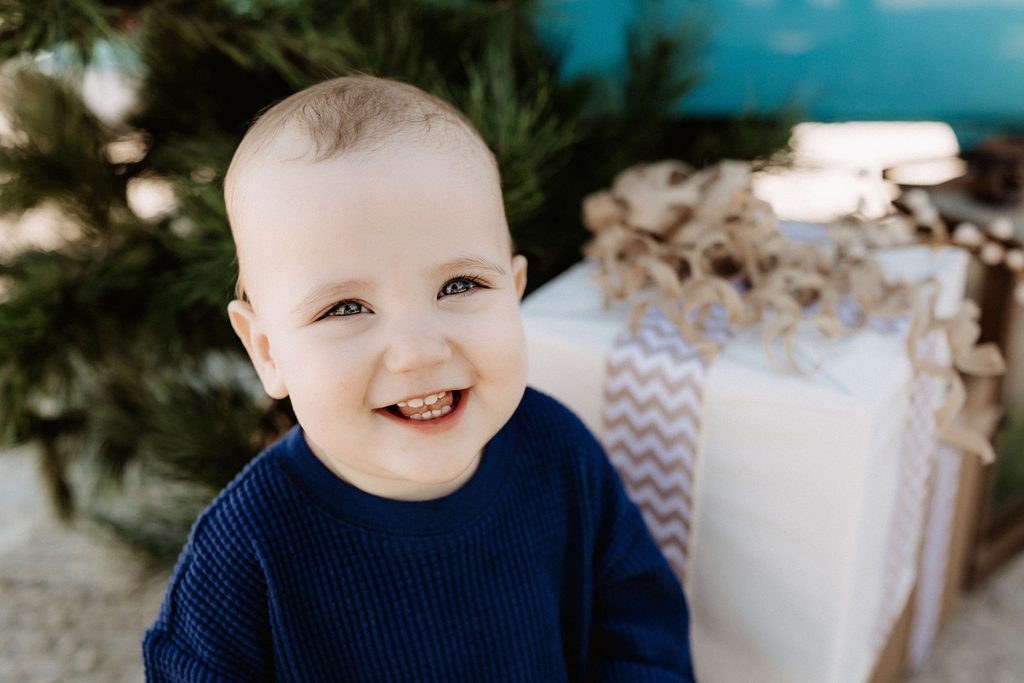 Christmas mini session setup with a decorated turquoise vintage blue bus on St. Pete Beach, Florida.