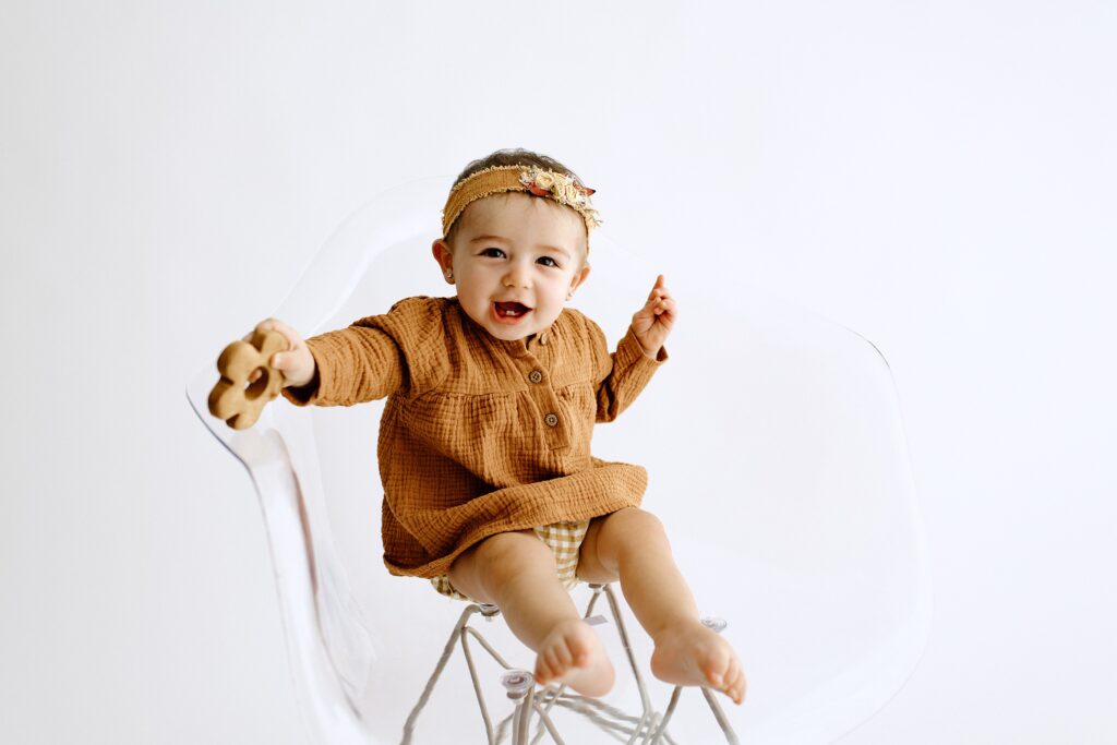 Family photography milestone session with baby on chair in studio in Tampa Bay, Florida Nadine B Photography 