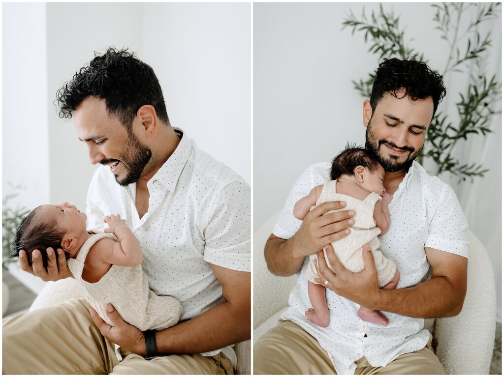 Newborn baby snuggling with dad in studio