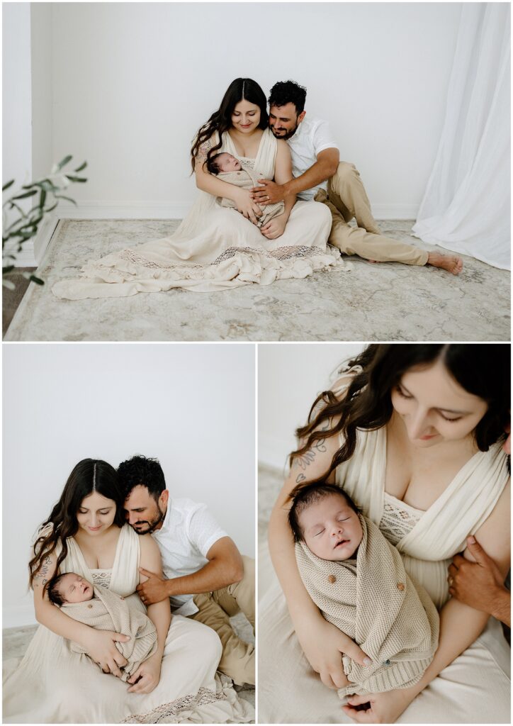 Mom and dad snuggling with newborn on rug in white Springhill Florida studio