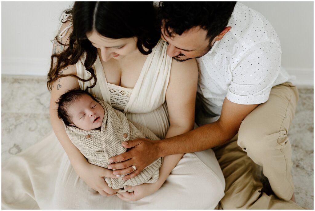 Close up portrait of newborn baby with mom and dad and hands on baby in Springhill Florida studio