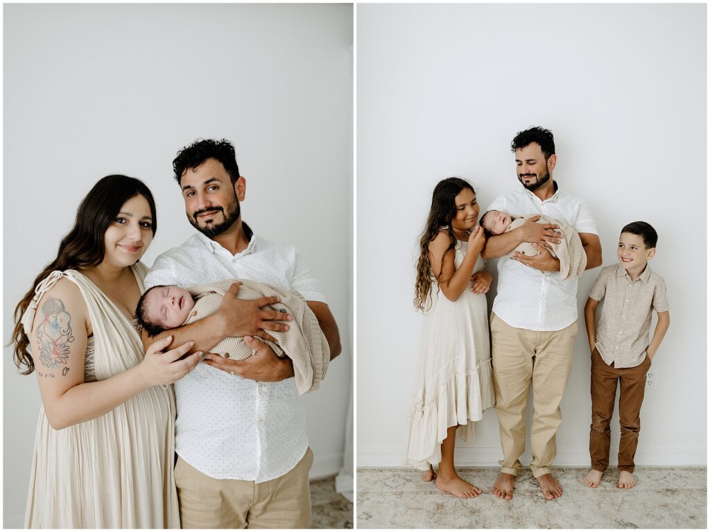 Mom and dad and brother and sister with newborn baby in front of white wall in Springhill Florida studio