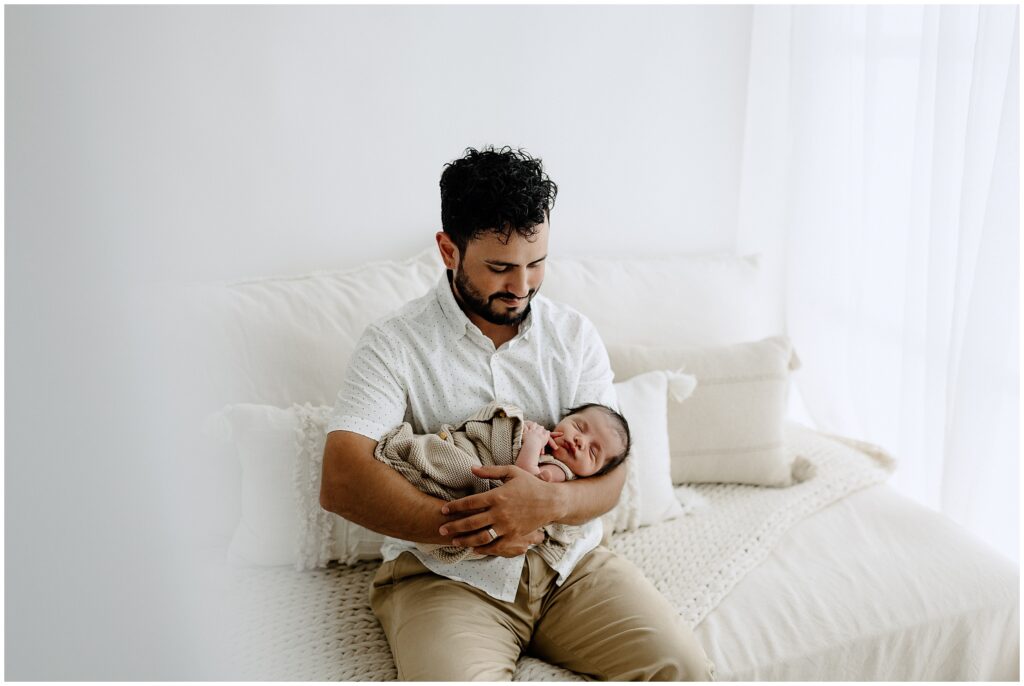 Dad holding newborn baby boy in Springhill Florida studio