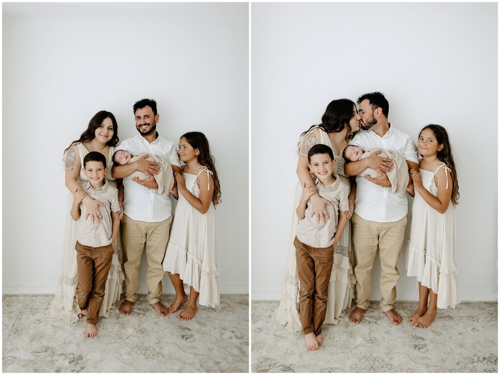 Family portraits of dad holding newborn baby in Springhill Florida studio with siblings