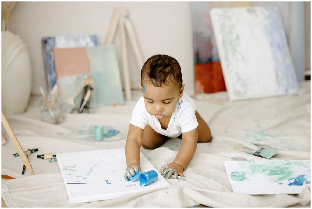 Son having fun with blue paint at springhill florida photography studio.