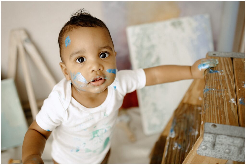 Happy little boy with paint all over him at springhill florida photography studio