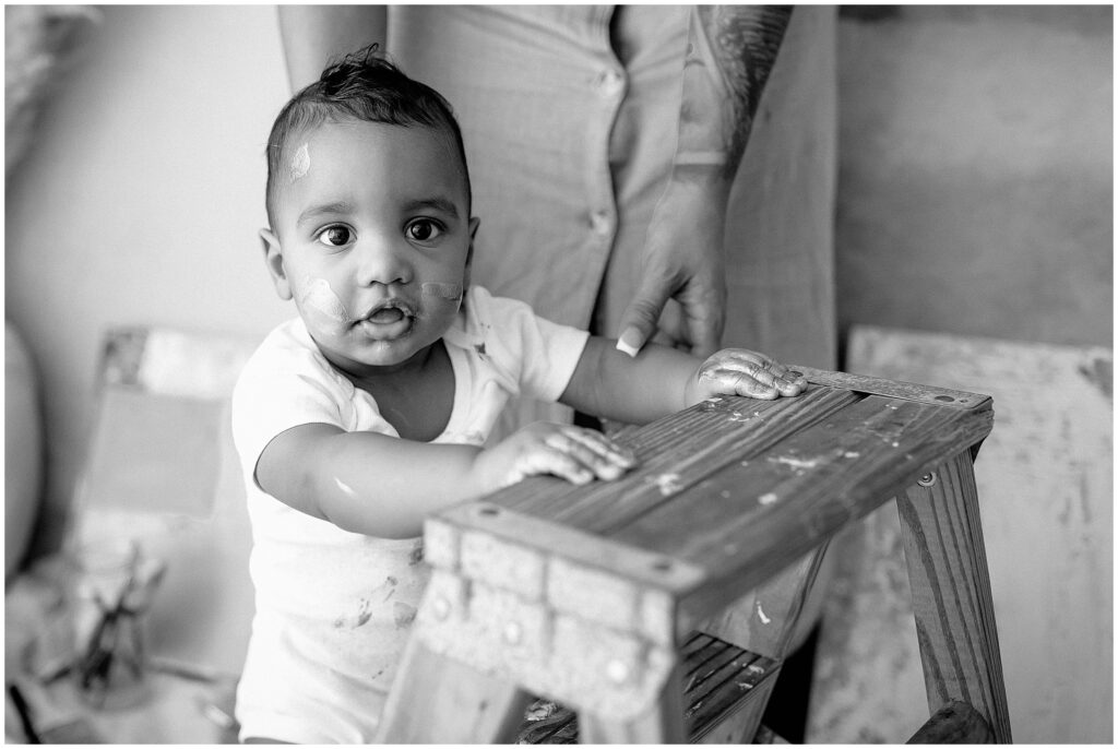 black and white portrait of little boy painting on a canvas at springhill florida photography studio