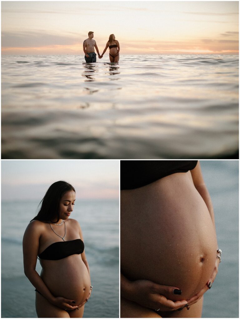 Maternity session of mom in black bikini and dad wearing board shorts while playing in water at sunset in springhill florida at beach