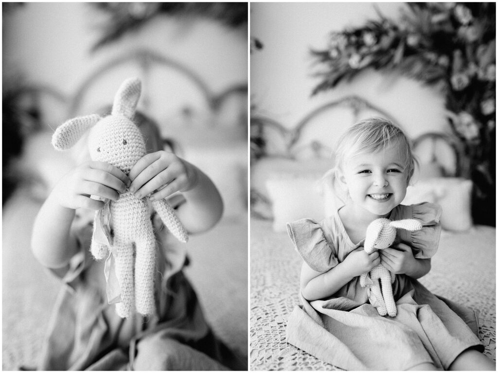 Black and white portraits of toddler girl playing with knit bunny stuffed animal in Springhill florida studio