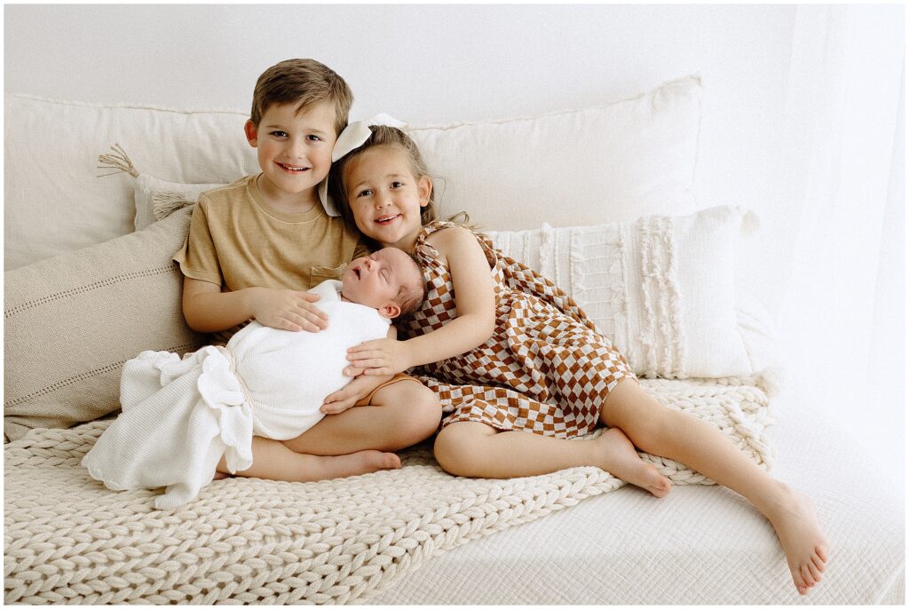 Siblings with their newborn sister at springhill florida photography studio