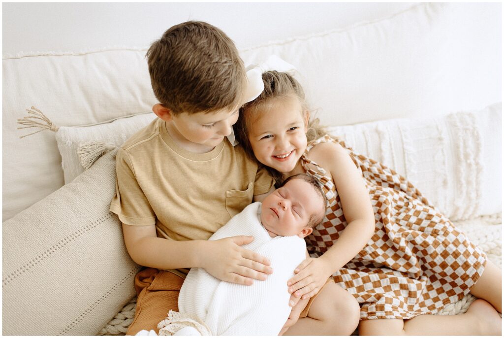 Siblings with their newborn sister at springhill florida photography studio