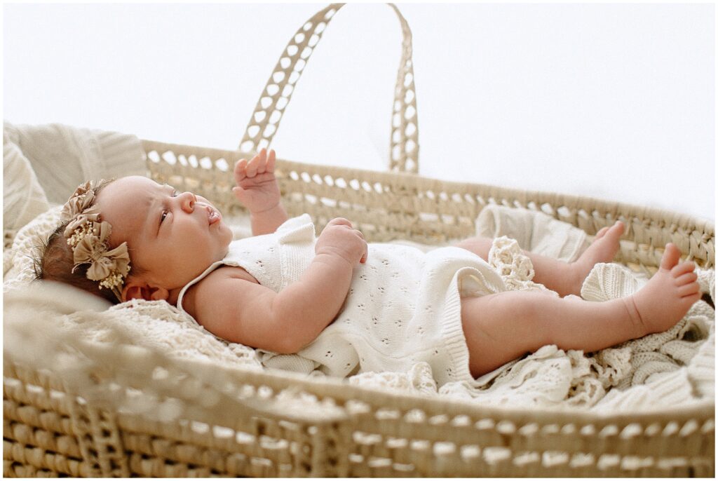 Precious moments with a newborn baby girl in floral crown in basket at springhill florida photography studio