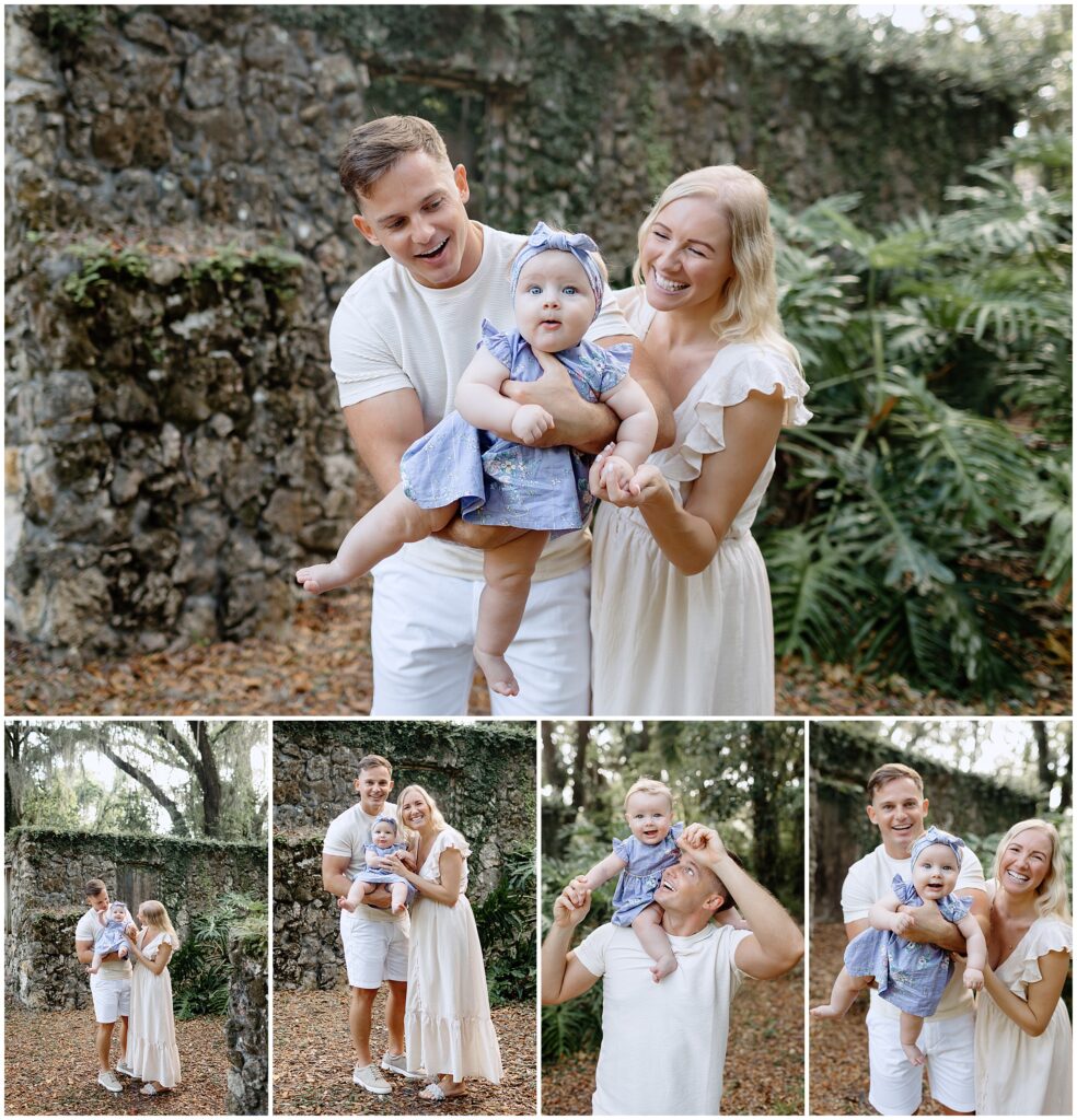 Mom and dad holding hands with baby in a blue and white floral dress, playing in front of ruins
