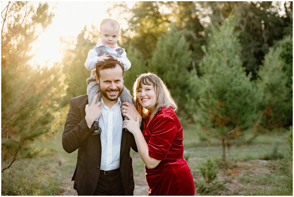 Fun moments captured with a family of three at Blue Acres Christmas Tree Farm, Shady Hill, Florida with son on dad's shoulders