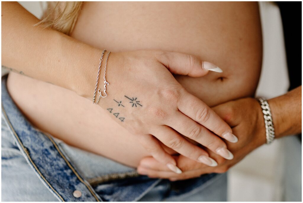 Hands on pregnant belly in jeans Spring Hill Studio maternity session