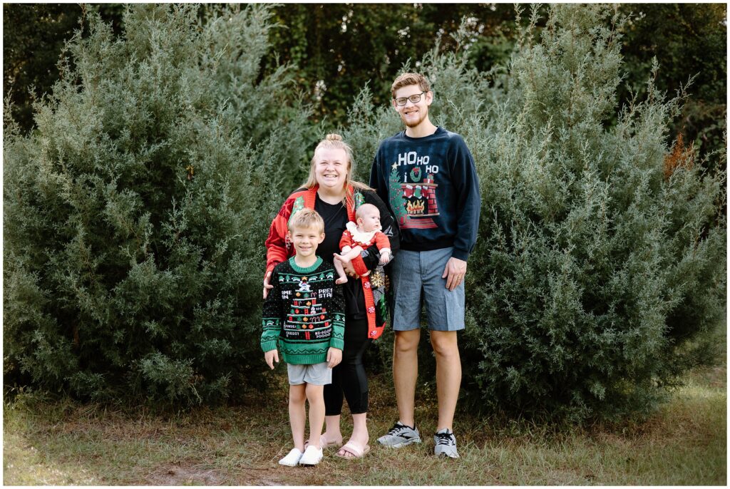 Family portrait among the Christmas trees at Blue Acres Christmas Tree Farm in Tampa