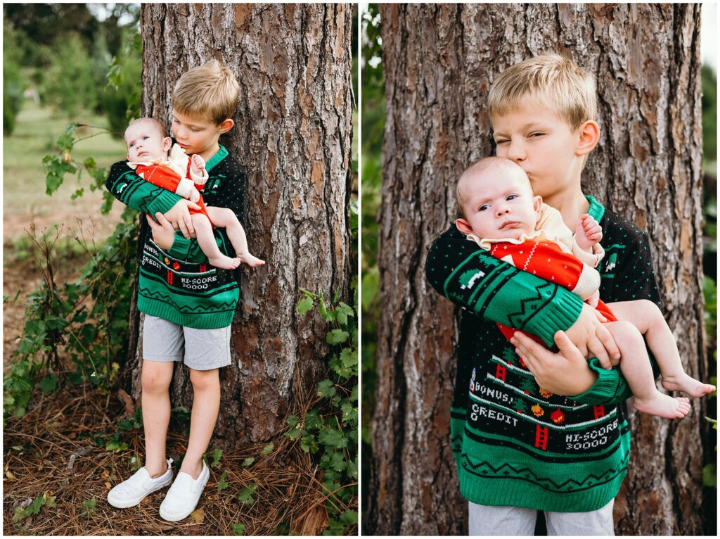 Little boy and baby girl standing by tree at Blue Acres Christmas Tree Farm in Tampa