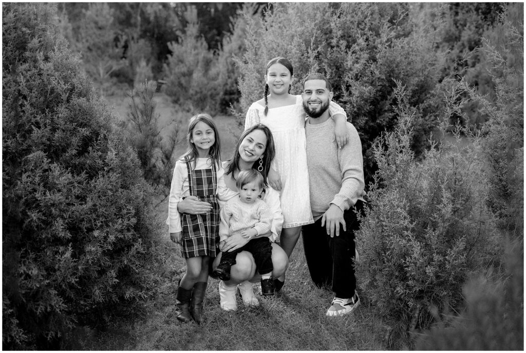 Black and white portrait of family at Blue Acres Christmas Tree Farm in Florida