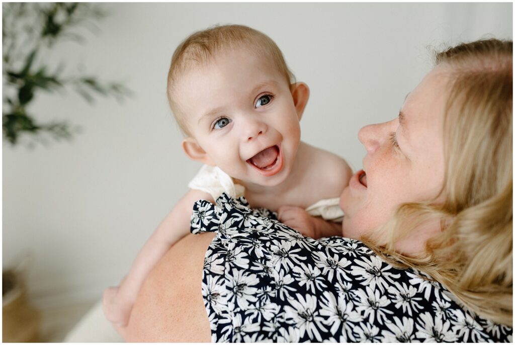 Close up portrait of mom and little girl laughing during family session Spring Hill Studio in Florida