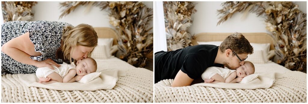 Mom and dad kissing sleeping daughter on bed Spring Hill Studio in Florida