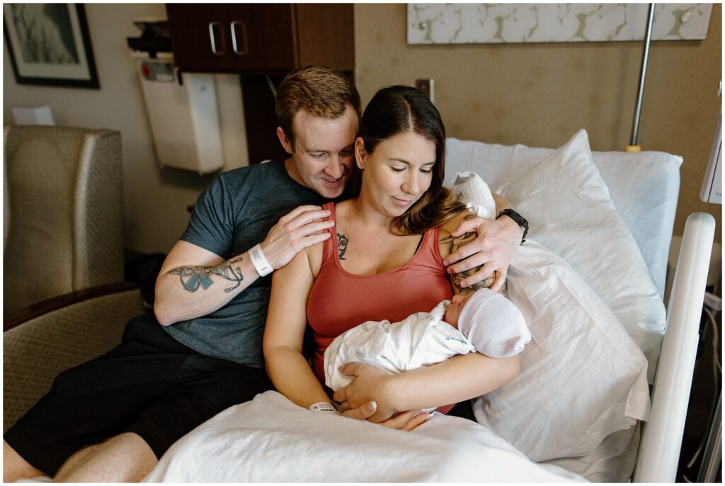 Mom and dad with newborn baby during fresh 48 hospital newborn session in Florida