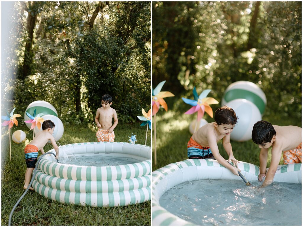 Boys giggling while playing with water and blow-up balls in the yard