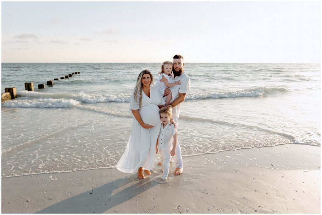 Family moment with parents and kids by water on Tampa beach