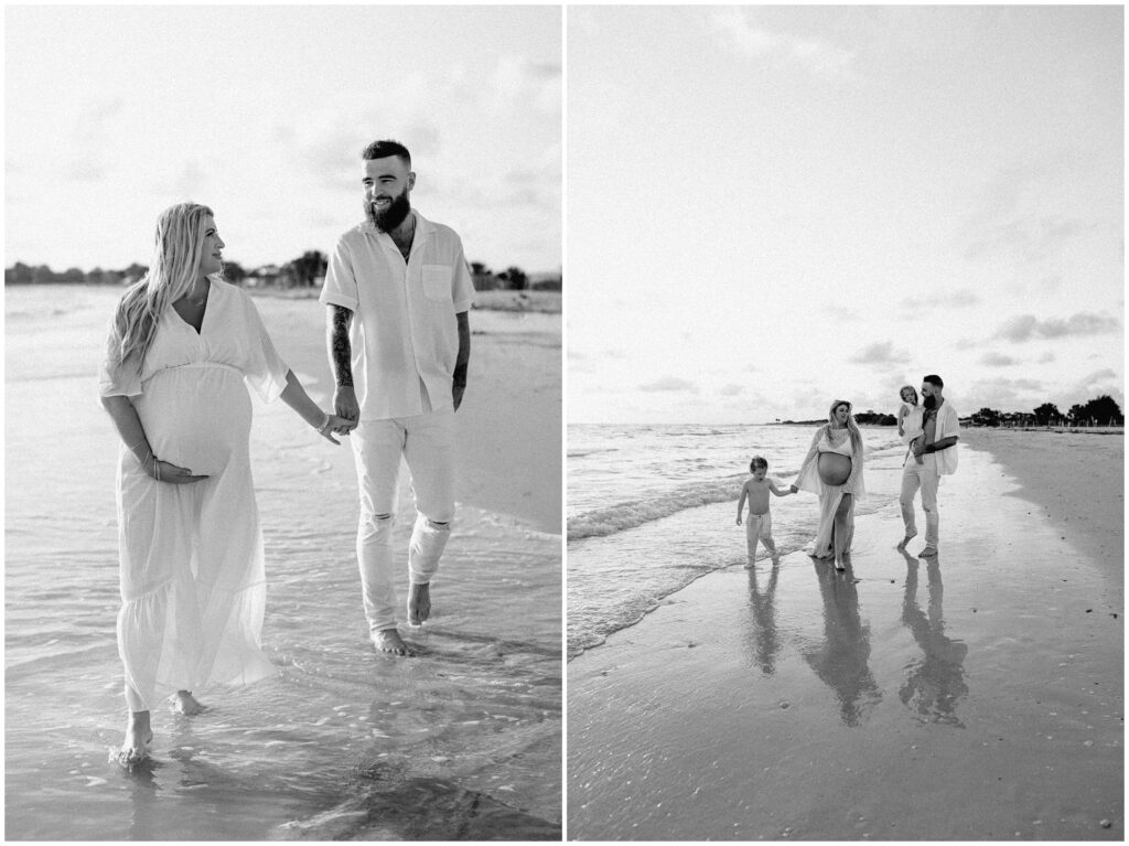 Black and white portrait of mom and dad holding hands and walking in water at Tampa beach