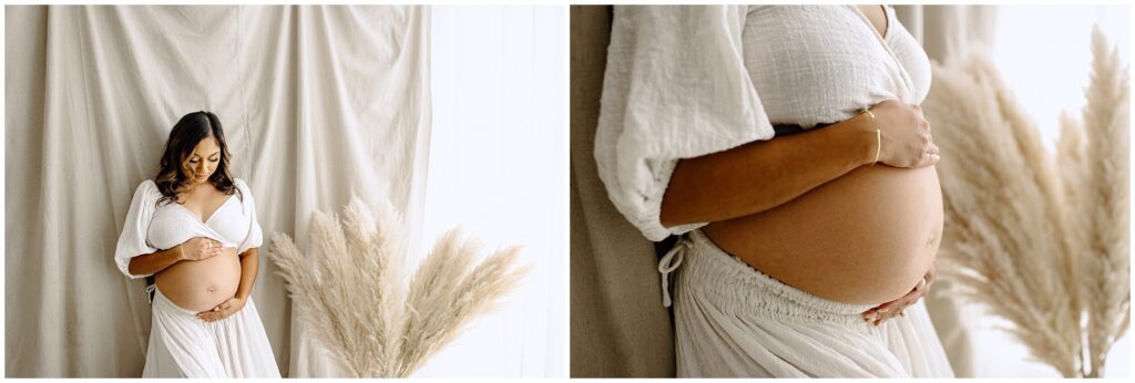 Close up portraits of pregnant woman holding belly in white top and skirt at Vibe Studio Spring Hill in Florida