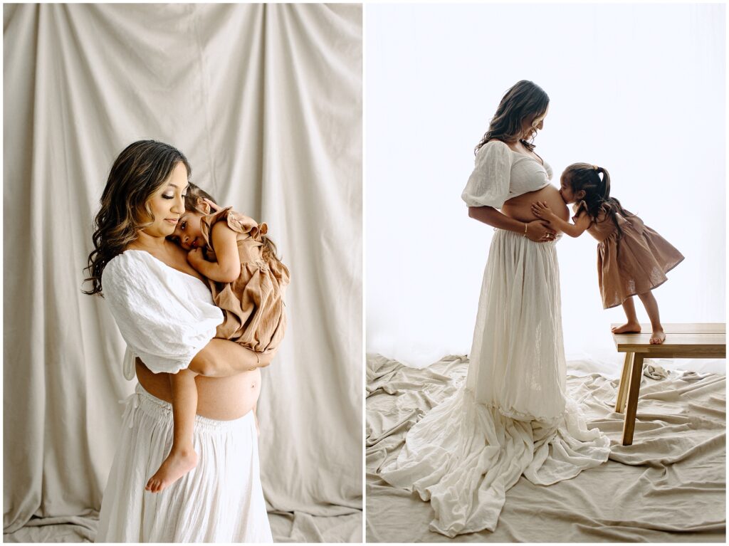 Pregnant woman snuggling with little girl in white two piece dress at Vibe Studio Spring Hill in Florida