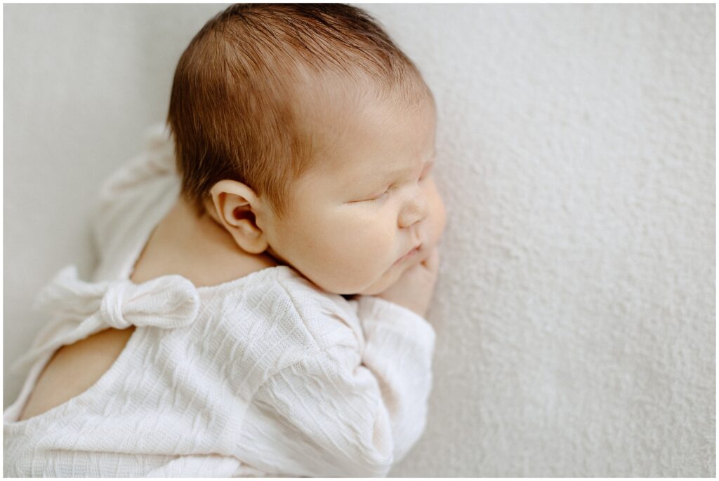 Close up detail portrait of little boy, newborn ears with hair in home newborn lifestyle photo session in Florida