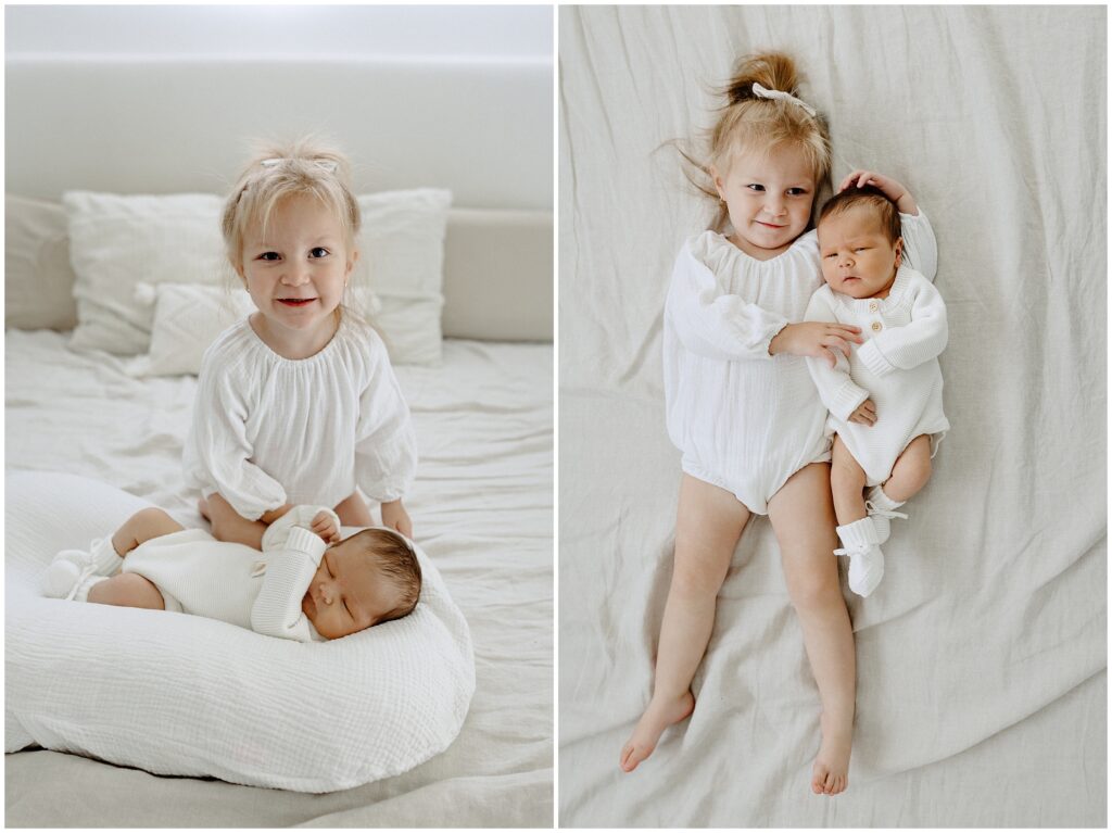 Little sister laying on bed with baby sibling during in home newborn lifestyle photo session in Florida