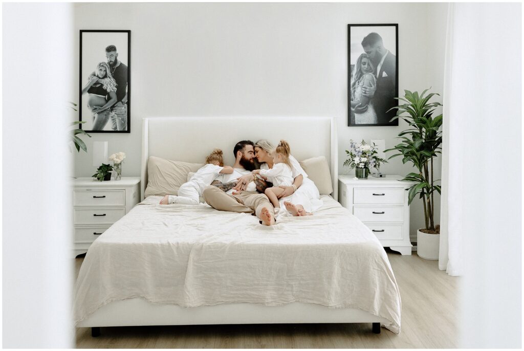 Family of 5 snuggling during newborn session at their home in Florida