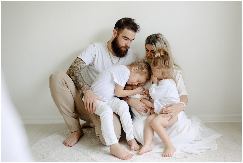 Family of 5 snuggling during newborn session at their home in Florida