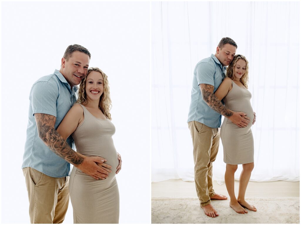 Pregnant woman in a nude dress with husband standing behind her holding her belly at Spring Hill Studio.