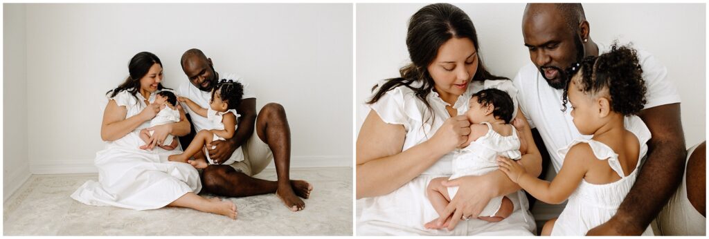 Family of 4 snuggling on floor in white during newborn session at Spring Hill Studio in Florida